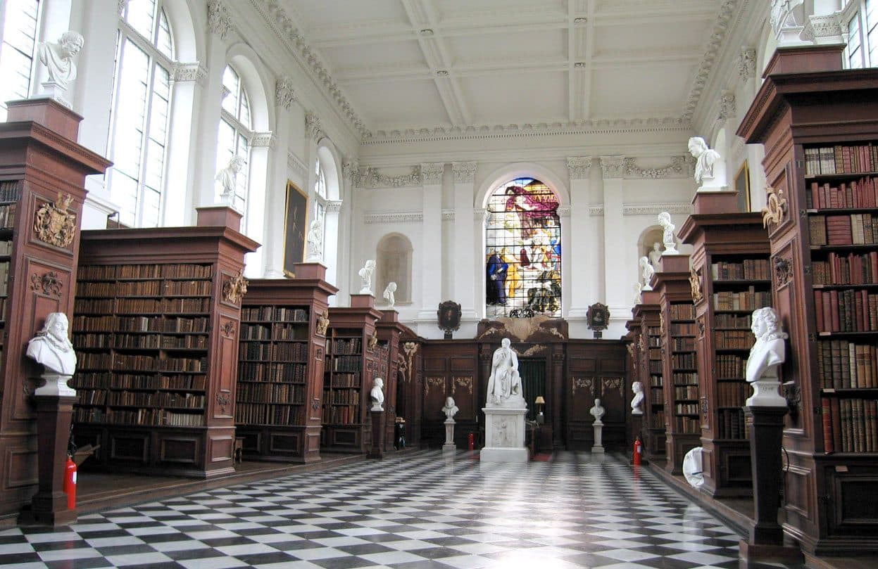 The Wren Library at Trinity College, Cambridge, with its rows of bookcases and a chequered floor