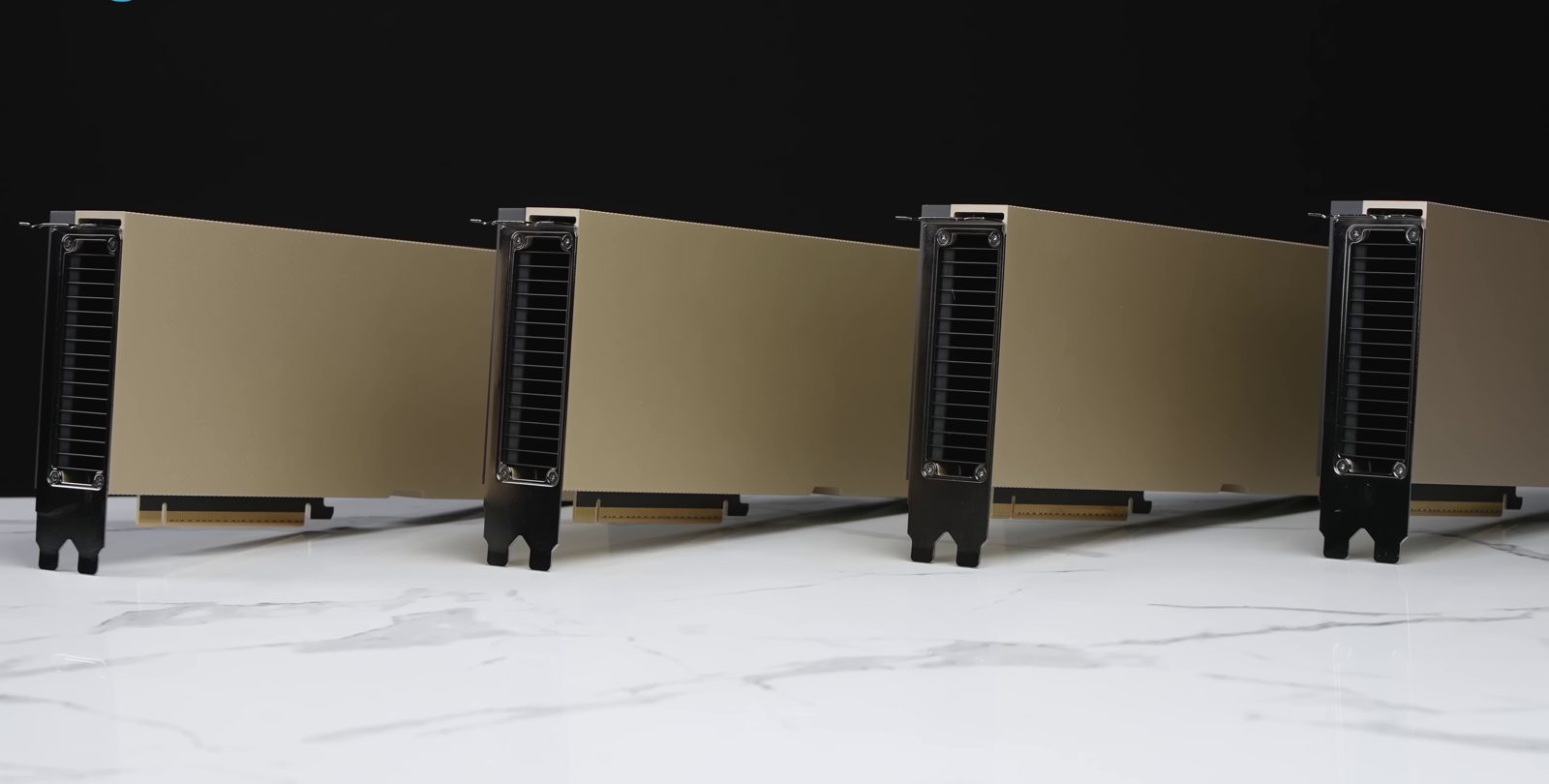 Four NVIDIA H100 PCIe cards standing in a row on a marble surface