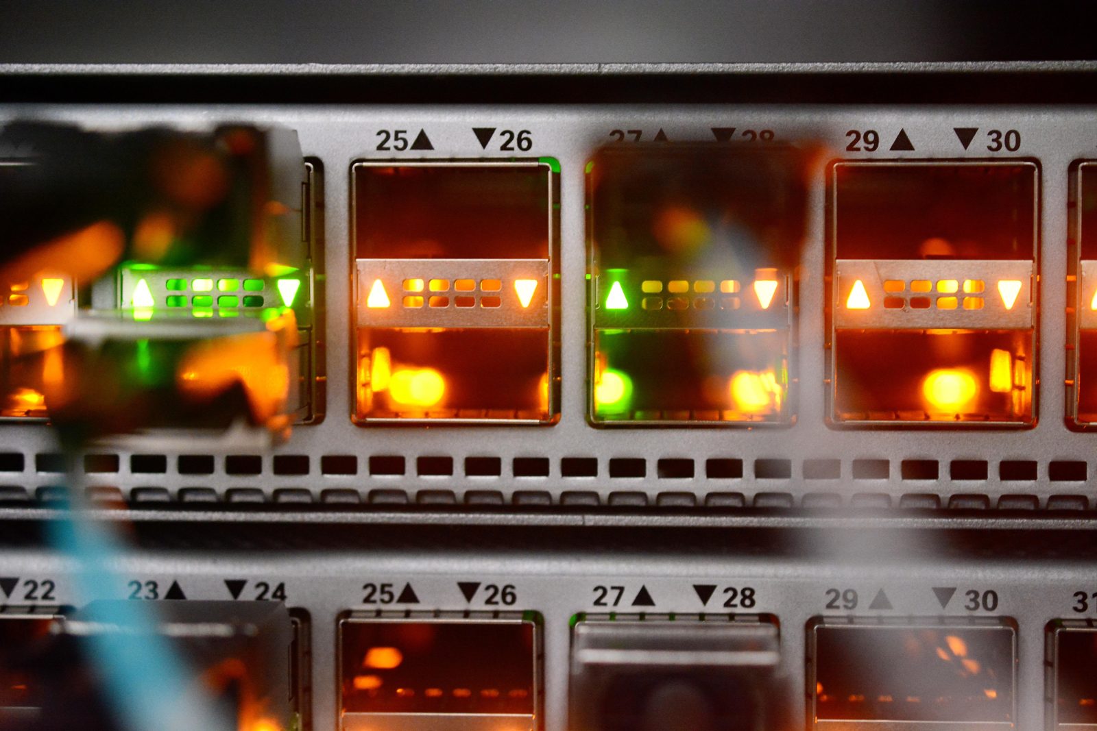 Close-up of a high-speed network switch with optical transceivers and fibre cables at the Datarmor computing centre