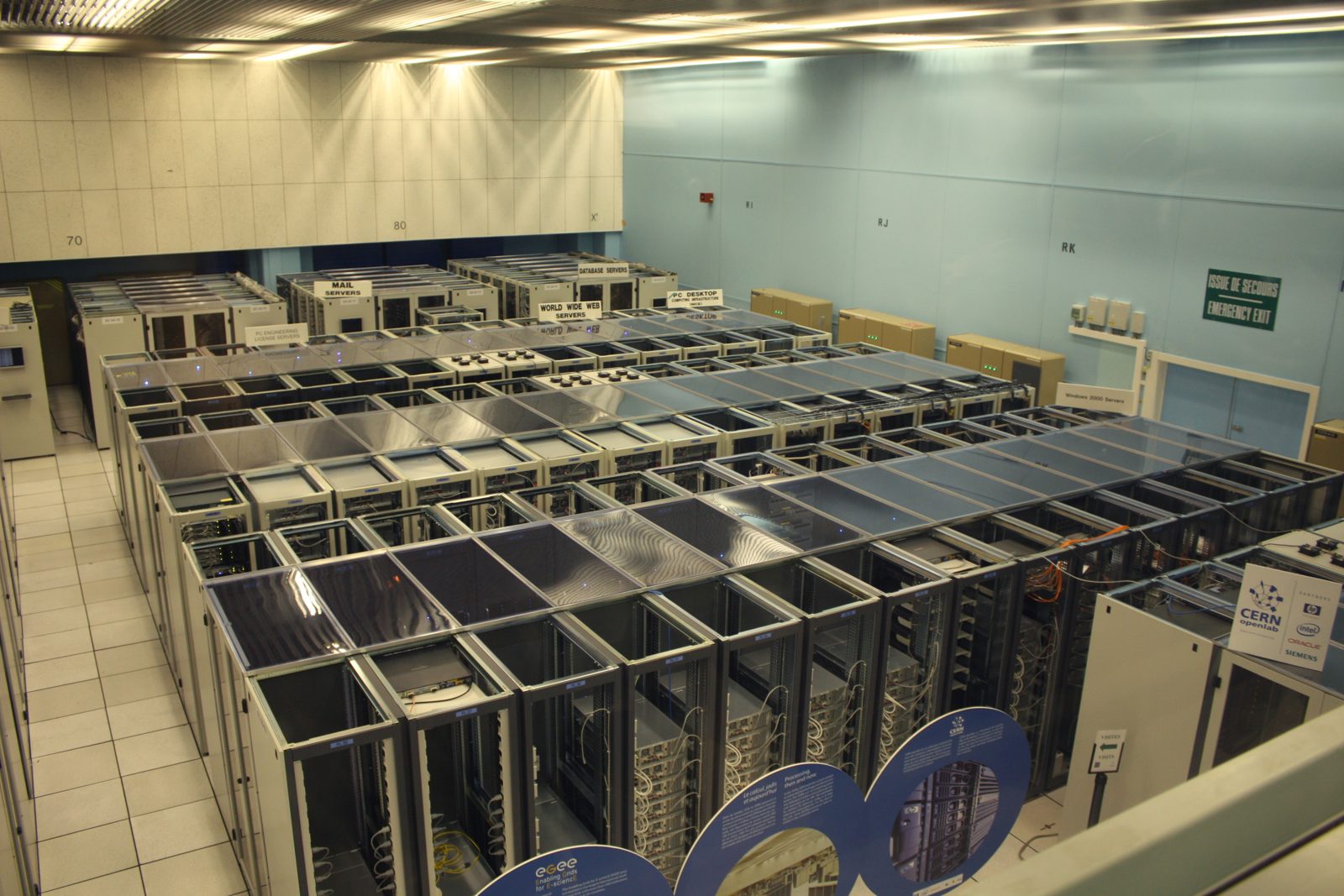 Rows of server racks in the CERN data centre, with the rear of the racks facing a hot aisle
